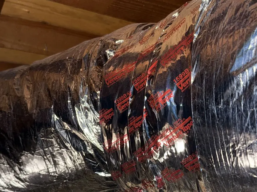Technician repairing insulated flexible ductwork