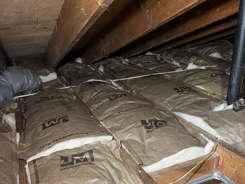 Attic with fresh insulation installed between joists